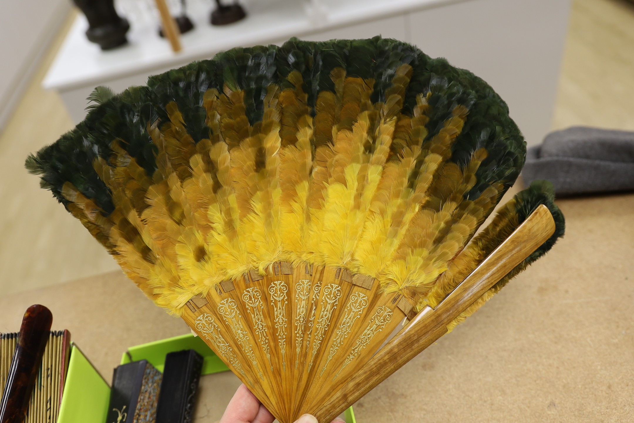 An unusual 19th century feather fan, three sequin and gauze fans, a paisley fan, Sandalwood fan and a collection of later fans and stick guards, feather fan 33cms high